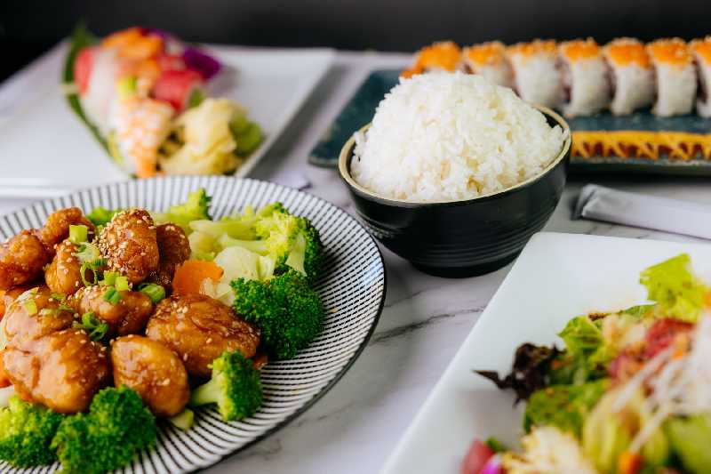 A variety of sushi rolls and rice served with a side salad, highlighting the fresh and flavorful options on the Sushi King menu in restaurants near me.