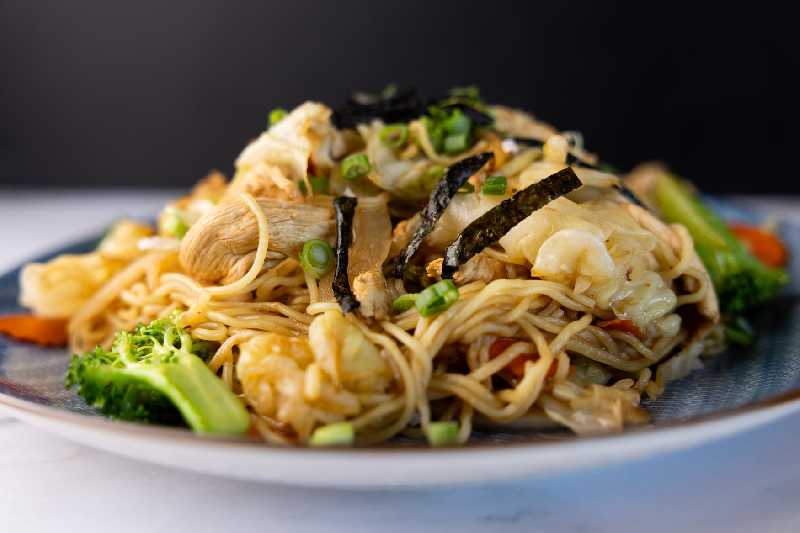 A plate of stir-fried yakisoba noodles with vegetables, showcasing a popular dish from Sushi King or similar Japanese restaurants, perfect for "food near me" searches in Albuquerque, NM.